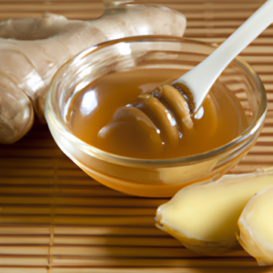 Organic ginger root beside a bowl of Lela’s ginger honey